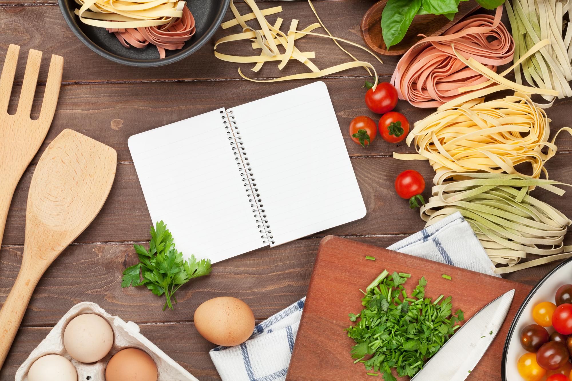 Stacked lesson notebooks and plated dishes